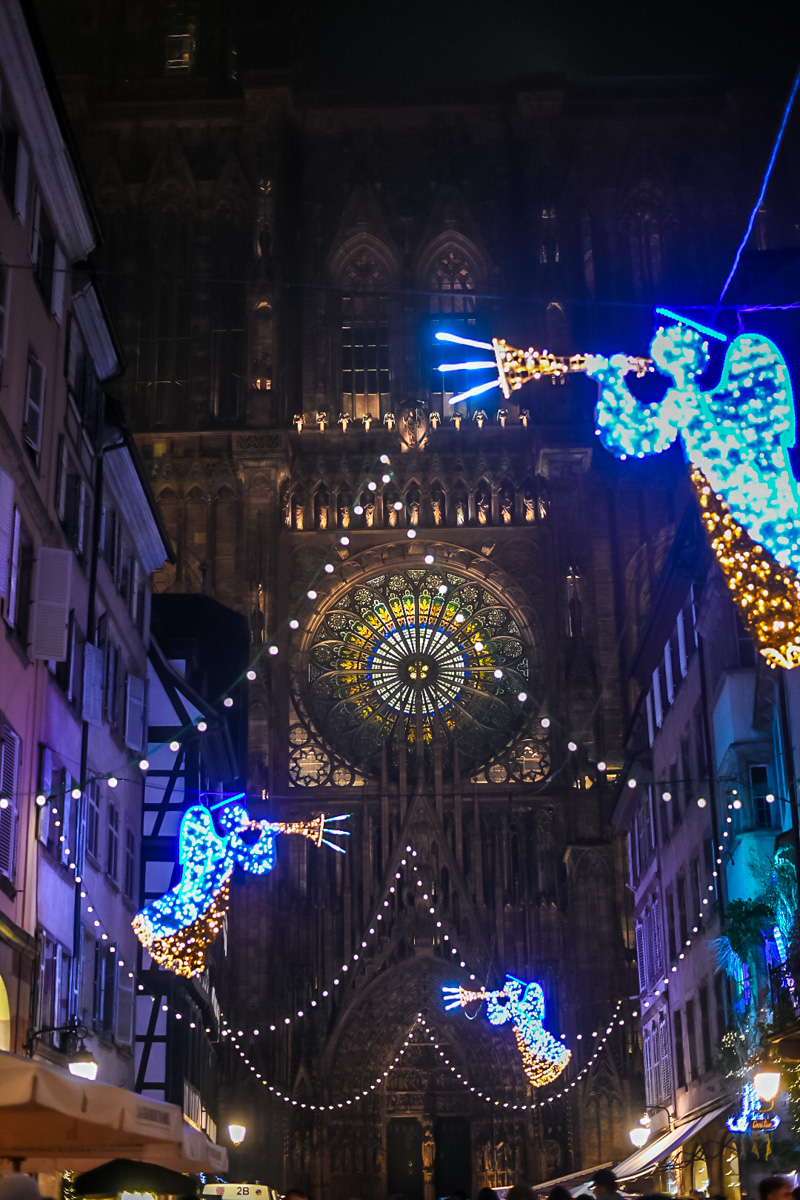 Metz’s Saint-Stephen Cathedral glows behind the city’s Christmas market filled with lights and artisan stalls.